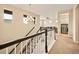 Bright hallway leading to living area and laundry room, featuring stylish chandelier and neutral tones at 7895 Julsburg Cir, Littleton, CO 80125