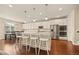 Bright, open kitchen features a large island with seating and stainless steel appliances at 7895 Julsburg Cir, Littleton, CO 80125