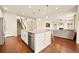 Bright kitchen with a large island, stainless steel appliances, and hardwood flooring at 7895 Julsburg Cir, Littleton, CO 80125