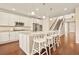 Open-concept kitchen boasts granite countertops, stainless appliances, and hardwood floors at 7895 Julsburg Cir, Littleton, CO 80125