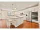 Spacious kitchen with stainless steel appliances, a large island, and hardwood floors at 7895 Julsburg Cir, Littleton, CO 80125