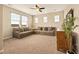 Spacious living room offers plush sofas, carpeted floor, and natural light with a relaxing atmosphere at 7895 Julsburg Cir, Littleton, CO 80125