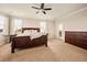 Spacious bedroom featuring carpet floors, ceiling fan, and access to a private outdoor patio at 7895 Julsburg Cir, Littleton, CO 80125