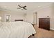 Serene bedroom with carpet, ceiling fan, and access to an outdoor patio, complemented by wood furniture at 7895 Julsburg Cir, Littleton, CO 80125