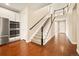 Elegant staircase features wood and white railings, with hardwood flooring leading to an open foyer and second story at 7895 Julsburg Cir, Littleton, CO 80125