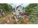 Aerial view of the landscaped backyard with patio and deck nestled in a wooded setting at 17420 Caribou Dr, Monument, CO 80132