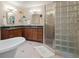 Bathroom featuring a soaking tub, glass-enclosed shower, and double vanity with granite counters at 17420 Caribou Dr, Monument, CO 80132