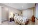 Bedroom with neutral paint, carpet flooring, bedside table, closet, and floral bedding at 17420 Caribou Dr, Monument, CO 80132
