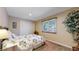 Bedroom with neutral paint, carpet, window with blinds, closet, and floral bedding at 17420 Caribou Dr, Monument, CO 80132