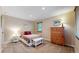 Bedroom with neutral paint, carpet, window with blinds, chest of drawers, and bedside tables at 17420 Caribou Dr, Monument, CO 80132