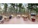 Inviting outdoor deck featuring comfortable wicker furniture, perfect for relaxation amidst a serene forest setting at 17420 Caribou Dr, Monument, CO 80132