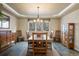Dining room features modern lighting, a window with backyard view, and traditional-style furniture at 17420 Caribou Dr, Monument, CO 80132