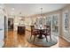 Bright dining area with wood floors, an island with seating and access to a spacious outdoor deck at 17420 Caribou Dr, Monument, CO 80132