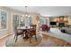 Open dining area boasts wood floors, large windows, and seamless access to an inviting living space at 17420 Caribou Dr, Monument, CO 80132