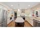 Bright, modern kitchen with white cabinets, stainless steel appliances, granite countertops, and hardwood flooring at 17420 Caribou Dr, Monument, CO 80132