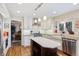 Modern kitchen with white cabinets, stainless steel appliances, island, and hardwood floors at 17420 Caribou Dr, Monument, CO 80132