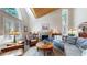 Bright living room with fireplace, vaulted ceiling, large windows, and comfortable seating arrangement at 17420 Caribou Dr, Monument, CO 80132