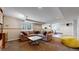 Large, carpeted living room with a neutral sectional sofa, a stylish coffee table, and bright natural light at 17420 Caribou Dr, Monument, CO 80132