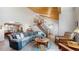 Spacious living room featuring a vaulted ceiling, a wooden staircase, and comfortable seating arrangements at 17420 Caribou Dr, Monument, CO 80132