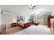 Spacious main bedroom with plush carpet, a fan, natural light, and ample closet space at 17420 Caribou Dr, Monument, CO 80132