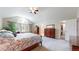 Bright main bedroom with vaulted ceiling, large windows, walk-in closet, and neutral carpet at 17420 Caribou Dr, Monument, CO 80132