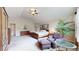 Spacious main bedroom with vaulted ceiling, sitting area, neutral carpet, and ceiling fan at 17420 Caribou Dr, Monument, CO 80132