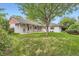 Spacious backyard with a covered patio and mature tree provides ample space for outdoor activities at 502 Nile St, Aurora, CO 80010