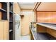 Basement bar area with shelving, sink, and retro refrigerator at 502 Nile St, Aurora, CO 80010