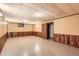 Spacious basement featuring wood paneling, drop ceiling, and vinyl floors is perfect for storage or activities at 502 Nile St, Aurora, CO 80010