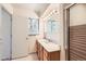 Bathroom features a shower and large vanity with wood cabinets and a large mirror at 502 Nile St, Aurora, CO 80010