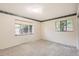 Bedroom with carpet floors, neutral paint, and two windows with exterior views at 502 Nile St, Aurora, CO 80010
