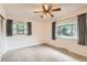 Spacious bedroom featuring neutral walls, carpet floors, and dual windows for natural light at 502 Nile St, Aurora, CO 80010