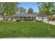 Charming home with manicured lawn, mature trees, and a two-car garage at 502 Nile St, Aurora, CO 80010