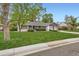 Well-maintained front yard with mature trees framing the classic home at 502 Nile St, Aurora, CO 80010