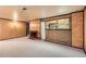 Comfortable living room showcases a charming fireplace, wood paneling, and a built-in bar area at 502 Nile St, Aurora, CO 80010