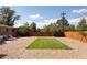 Spacious backyard with rock ground cover, a rectangular grass patch, and a privacy fence at 5915 W 5Th Ave, Lakewood, CO 80226