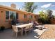 Backyard patio area with a grill, outdoor dining table, and lounge chairs at 5915 W 5Th Ave, Lakewood, CO 80226