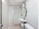 Bathroom featuring tiled walk-in shower and pedestal sink at 5915 W 5Th Ave, Lakewood, CO 80226