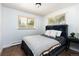 Bedroom featuring wood floor and two windows with natural light at 5915 W 5Th Ave, Lakewood, CO 80226