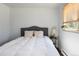 Bedroom filled with natural light features a window, comfortable bed, and side table decor at 5915 W 5Th Ave, Lakewood, CO 80226