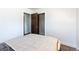 This bedroom has a cozy bed with a decorative blanket and access to a closet and another room at 5915 W 5Th Ave, Lakewood, CO 80226