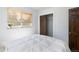Bright bedroom featuring a window with blinds and a wood closet door with a second door nearby at 5915 W 5Th Ave, Lakewood, CO 80226