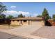 Charming brick home featuring a well-manicured lawn and a two-car garage at 5915 W 5Th Ave, Lakewood, CO 80226