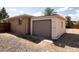 Image of a detached garage in a backyard with a large door and gravel ground cover at 5915 W 5Th Ave, Lakewood, CO 80226