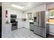 Bright kitchen with white cabinets, stainless steel appliances, and tiled floor at 5915 W 5Th Ave, Lakewood, CO 80226