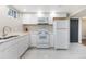 Bright kitchen features white cabinets, modern appliances, and ample counter space for cooking and entertaining at 5915 W 5Th Ave, Lakewood, CO 80226