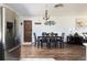 Bright kitchen and dining room features stainless steel refrigerator and modern fixtures at 5915 W 5Th Ave, Lakewood, CO 80226