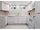 A well-lit kitchenette is equipped with modern appliances, sleek countertops, and ample cabinet space at 5915 W 5Th Ave, Lakewood, CO 80226