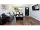 Comfortable living room featuring hardwood floors and a black front door at 5915 W 5Th Ave, Lakewood, CO 80226