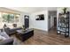 Bright living room featuring hardwood floors, a gray sofa, and modern accents at 5915 W 5Th Ave, Lakewood, CO 80226